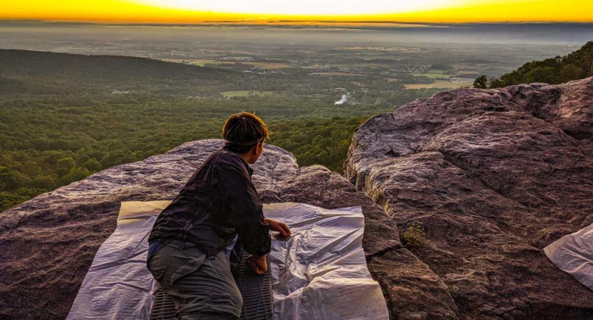 a student looks out over the horizon on an outdoor program for youth